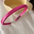 Detail shot of a hot pink satin padded headband with premium glossy fabric texture - Rose Red