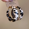 Detail view of geometric round earrings with black and white zebra pattern on card - Black White Zebra