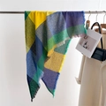 Detail of colorful plaid scarf showing woven texture and fringe trim on a metal hanger - Green Yellow