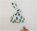 Close-up of cream canvas wristlet knot bag featuring green cartoon tree patterns - Smiley Green Tree