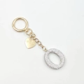 Golden keychain featuring sparkling letter O charm and I Love You heart pendant - Letter O