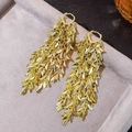 Detailed macro view of gold layered tassel earrings with leaf-shaped metal pendants - Gold Multi-Layer Leaf Tassel (187)