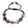 Detailed macro shot of hand-woven bracelet with heart-shaped purple agate and black cord - Purple