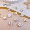 Macro shot of 9x9mm silver heart-shaped and irregular baroque-style nail art charms - Bright Silver (9*9mm)