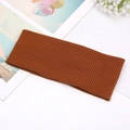 Close-up of brown ribbed knit headband on white textured background with decorative flower - Brown
