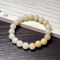 Cat paw Bodhi root bracelet with 21 warm white cream beads in a zen style layout - Creamy Yellow Round Beads