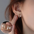 Elegant gold hoop earrings with white faux pearl and shell inlay on a female model - Gold Shell Pearl