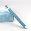Close-up of sparkling sky blue rhinestone ballpoint pen with a large crystal diamond top - Lake Blue