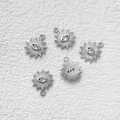 Close-up of five silver sunburst evil eye charms with cubic zirconia for DIY jewelry - Silver