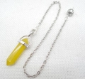 Detail view of a yellow crystal hexagonal pendulum pendant with a fine silver metal chain - Citrine