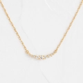 Collana minimalista a sorriso in oro con nove zirconi graduati su una sottile catena dorata - Oro rosa