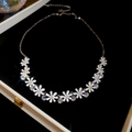 Detail of white daisy flower necklace with zircon tassels in a black velvet jewelry box - Necklace