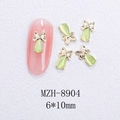 Nail art charms featuring green teardrop cat-eye stones in gold frames, 6x10mm size detail - Gold Butterfly Light Green Cat Eye Style (8904)