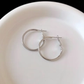 Polished silver metal hoop earrings with secure click closure on white ceramic tray - Plain Circle Hoop (Silver Earring Post)