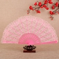 Pink lace folding fan with golden floral patterns on an elegant wooden stand - Pink