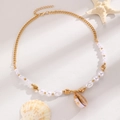 Bohemian gold chain necklace with white pearls and natural seashell pendant detail - KC Gold Pearl Shell Necklace (5755)