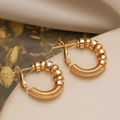 Chic punk style gold-plated hoop earrings with polished beads on a textured surface - Beaded Threaded Style / Gold