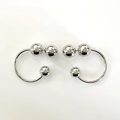 Detailed top view of silver C-shaped metallic hoop earrings with polished bead accents - Silver