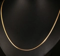 Close-up of golden stainless steel flat snake chain necklace on a black mannequin bust - 3mm Round Snake Chain 50cm / Gold