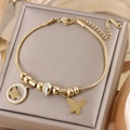 Detailed close-up of gold plated butterfly charm and rhinestone pendant on steel bracelet - Gold B-248G (Butterfly/Rhinestone Ring)