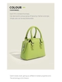Detail view of light green Boston handbag featuring silver zipper and smooth PU leather - Green
