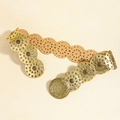 Detailed macro view of vintage gold hollow circular metal buckles on a khaki leather belt - Antique Bronze Gold