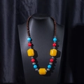 Detailed view of handmade ethnic ceramic necklace with brown wood beads and colorful accents - X470-16 Yellow Mixed Color