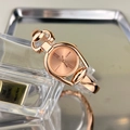 Detail view of a rose gold quartz watch with horsebit bracelet and Roman numerals - Rose Gold