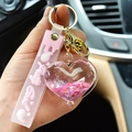 Pink heart-shaped quicksand keychain with liquid glitter and cute bell for backpacks - Pink