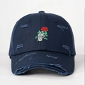 Distressed dark blue baseball cap featuring skull hand holding red rose embroidery - One Size / Navy Blue