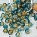 Detail of 10mm cracked glass beads with gold thread on a textured white background - Dunhuang Style