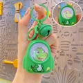 Green dinosaur keychain with glowing light and sound features held by hand - Backpack Night Light-Green Dinosaur