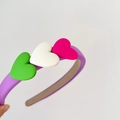 Detail of purple sponge headband featuring colorful green, white and pink heart ornaments - Purple Hoop