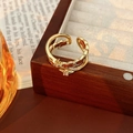 Detail of vintage gold double-layer open ring with star-shaped zircons on a wooden box - Double Layer Star With Zirconia Style / Ring-Gold-Brown-Double Layer