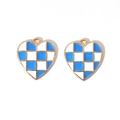 Detailed macro view of two blue and white checkered enamel heart charms with golden edges - Gold Tone Blue White Checkerboard Heart