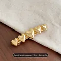 7.5cm gold heart-shaped metal spring hair clip with a polished finish and five-heart design - Gold Heart Spring Clip
