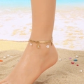 Detail of layered gold anklet with turtle, pearl and flower charms on a woman's ankle - Turtle Pearl Flower Style (KJ4154-SXSJ)