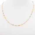 Detail view of a gold beaded necklace with colorful enamel charms on a white jewelry display - Gold + Colorful 1