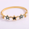 Detail of gold titanium steel bangle with colorful enamel stars and turquoise stones - Pentagram Horseshoe Bangle