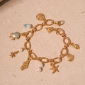 Bracciale dorato stile marino con ciondoli a stella marina, tartaruga e conchiglia - Bracciale Stella Marina e Tartaruga Oro