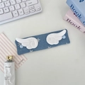 Blue denim fabric cable organizer with white plush angel wings decoration on table - Denim Star Dark Blue