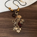 Detail of vintage flower ceramic bead necklace with heart lock and moon star charms - Punk Pendant/Leather Cord Style