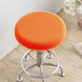 Vibrant orange round stool cover with waffle texture on a rolling metal stool - Orange