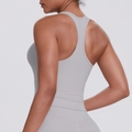 Detail of light blue racerback sports top showing slim fit and back design on model - Frost Grey