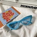 Detail of bright blue cat-eye sunglasses with thick frame on white fabric background - Cat Eye / Sky Blue Frame Blue Lens
