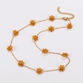 Elegant gold chain necklace featuring amber daisy flower beads with a secure lobster clasp - Orange