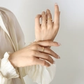French style gold plated titanium steel braided rings worn by model with silk shirt - Adjustable Open / Gold Slim Braided Ring