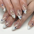 Detail of white French almond nails with gold star rivets and blue rhinestones - Bz1413 Starry Sky / Glue Type