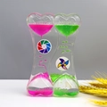 Detail of dual heart-shaped liquid motion timer with pink and green droplets and tiny windmills - SY01 New Windmill Green Pink