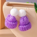 Detailed view of handmade purple knitted hat earring with white pompom and silver hook - Purple